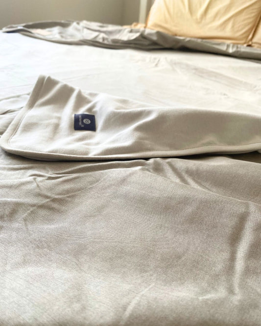 Stay cozy and protected with the Radia Smart® Mega Large EMF Protection Bed Blanket in Grey. Made from 100% cotton and silver-lined Faraday fabric, it blocks EMF, RF, and 5G radiation for a safer sleep environment. This breathable, soft bed blanket doubles as a bed sheet, offering full-body coverage and comfort while reducing wireless exposure. Ideal for promoting restful sleep and overall wellness in today’s connected world.
