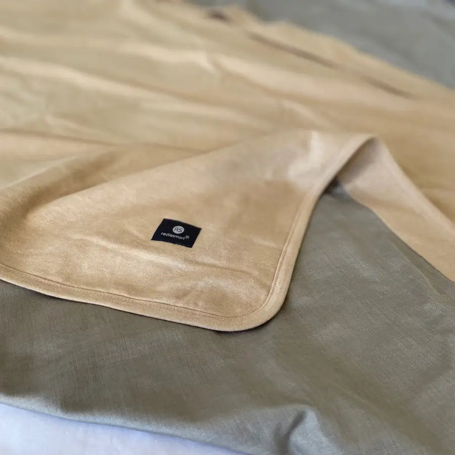 Stay cozy and protected with the Radia Smart® Classic XL Organic Cotton Bed Blanket. Crafted with silver-lined Faraday fabric, it provides powerful EMF protection by shielding against RF and 5G radiation. This extra-large, breathable, and soft blanket supports restful sleep and overall wellness. Ideal for daily use, it offers full-body coverage and reduces exposure to wireless signals in a natural, organic, and comfortable design.